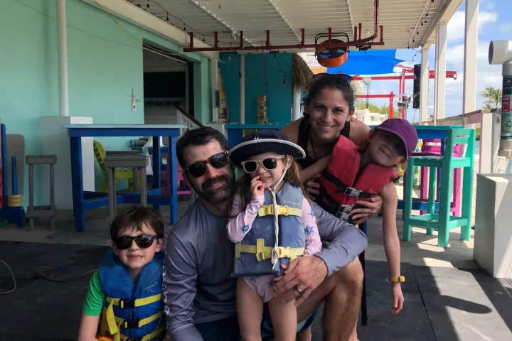 Family smiling after their kayak rental