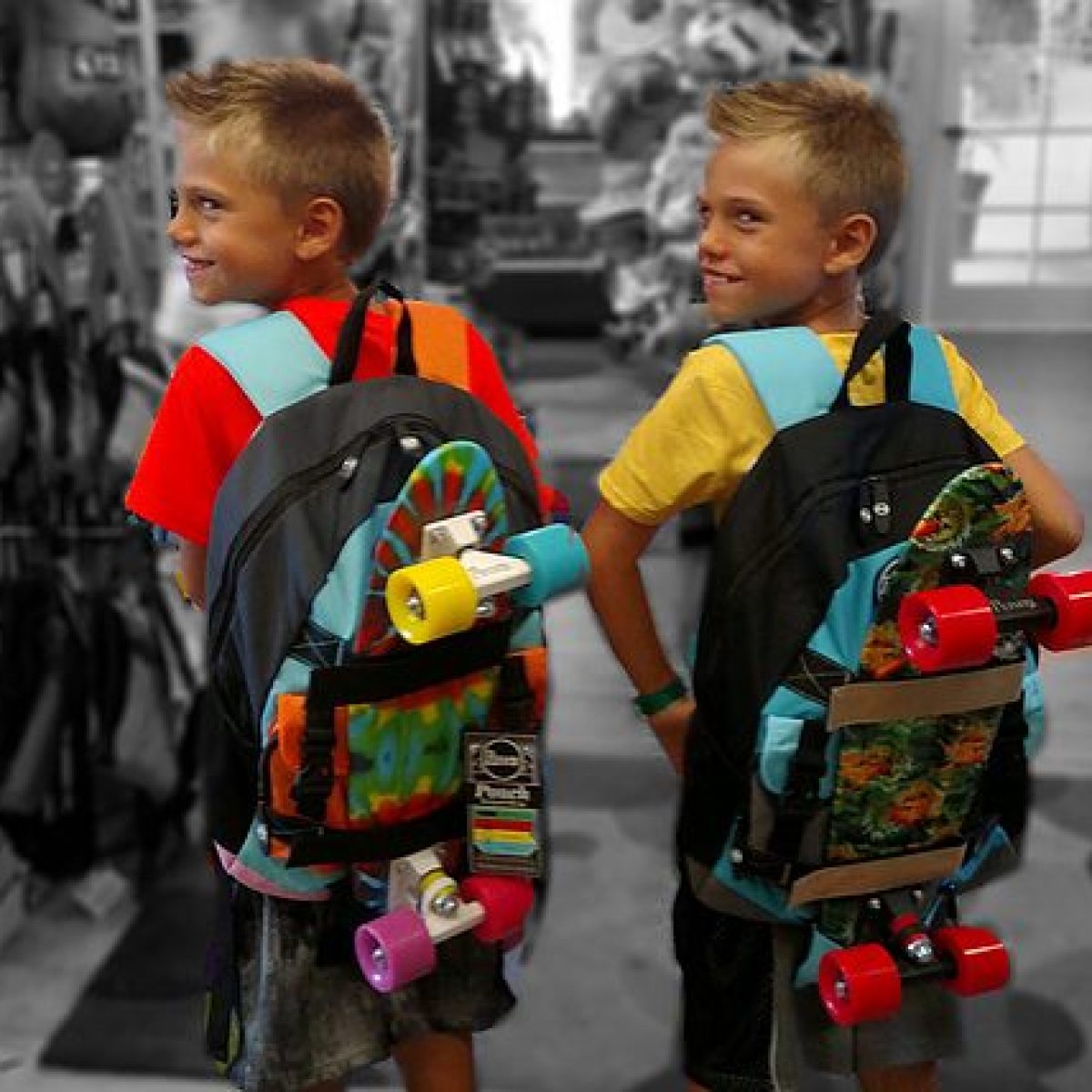 boys with skateboards on their backpacks